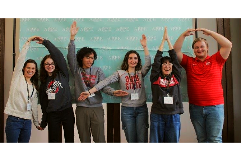 Members of the 2024-2025 team create the letters O-H-I-O with their arms while at the Regional Competition.