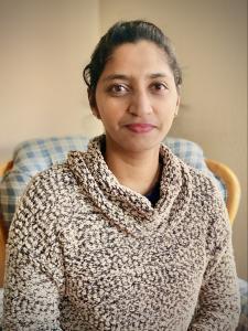 Manbir Rakker wearing tan sweater