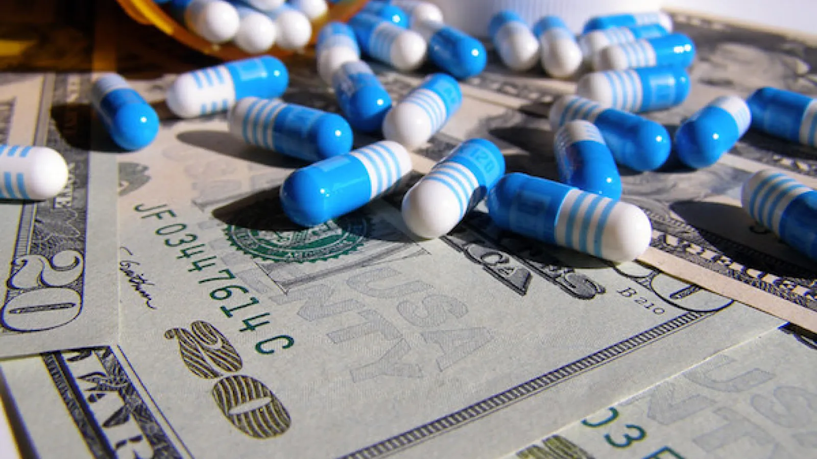 Stock photo of pills on bills.