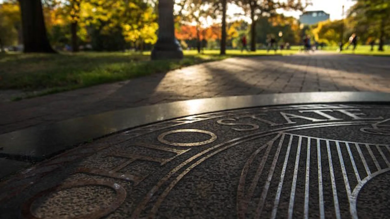 OSU seal on the sidewalk in the rays of morning light