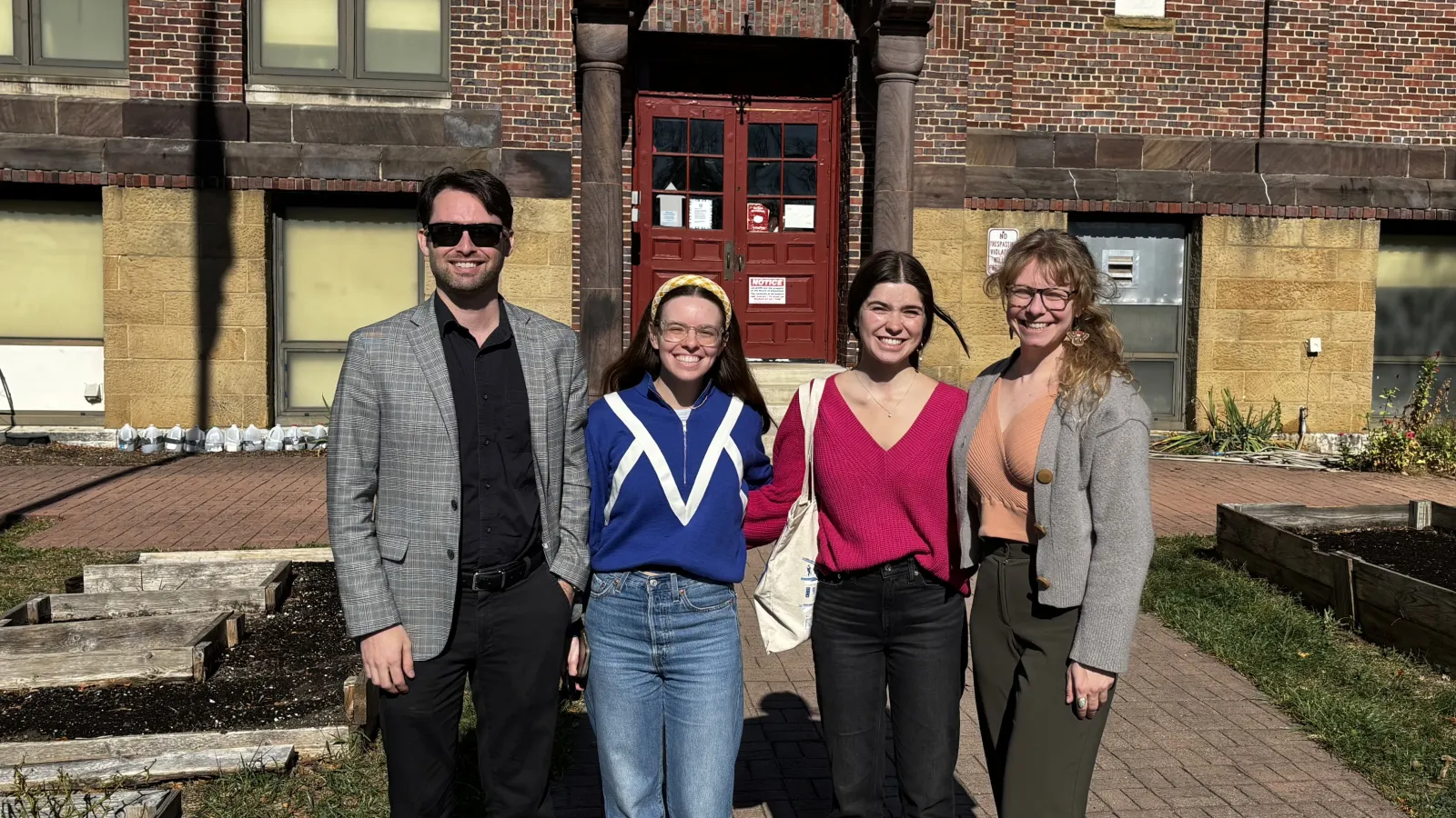 Aaron Yarmel, Layne Garrelts, Zoe Lightcap, and Jamie Herman standing outside Columbus Gifted Academy