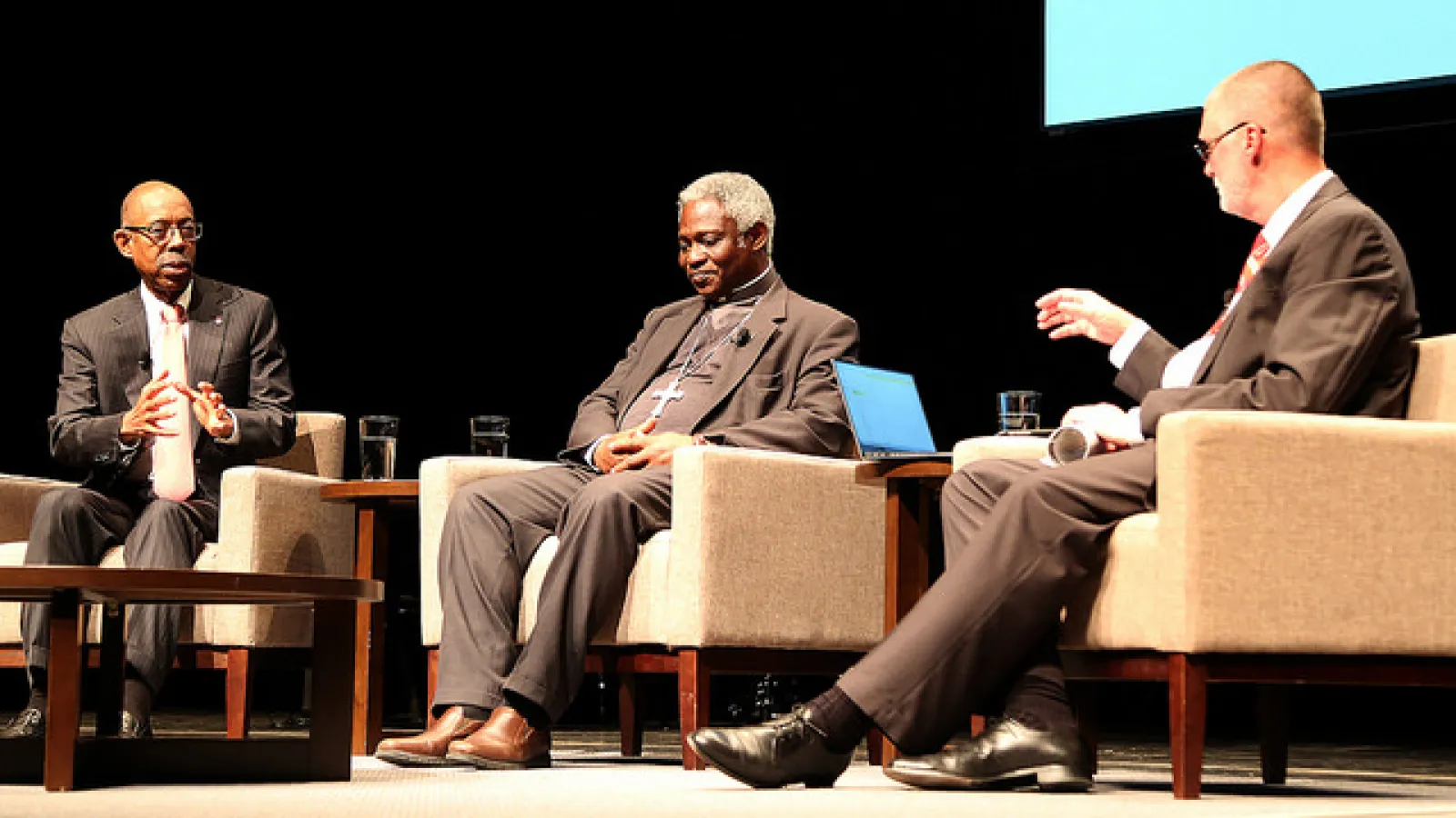 Cardinal Peter Turkson enjoys a fireside chat with President Drake