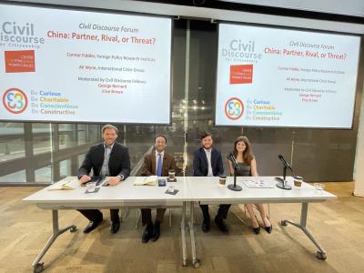 Two speakers and two civil discourse fellows sitting at a table ready to begin a civil discourse forum