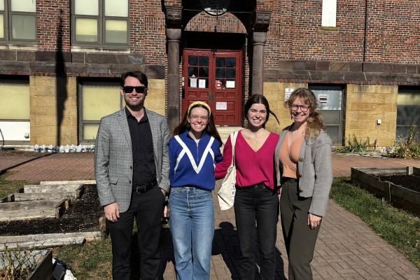 Aaron Yarmel, Layne Garrelts, Zoe Lightcap, and Jamie Herman standing outside Columbus Gifted Academy