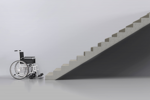 Wheelchair against white background in front of set of stairs